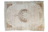 Vintage Oushak carpet, ornate medallion, subtle abrashes in ivory and blanched wood tones.