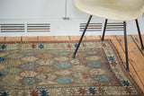 Early 20th century Caucasian rug border and field detail with geometric motifs in madder red and blue.