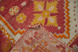 Cherry red Oushak rug pile with saffron yellow pinwheel motifs and hand-knotted foundation.