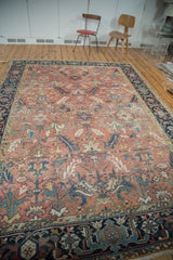 Blanched vintage Heriz carpet with faded cinnabar red field and expressive serrated leaves.