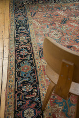 Original side cord selvage, geometric border, and blush field of a vintage Heriz carpet.