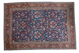 Antique Persian Mahal carpet, sprawling allover floral-vine design in indigo, red, and cream.