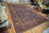 Antique Persian Mahal carpet's indigo field with sprawling allover floral and panel outlines, rust border.