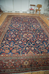 Detailed view of antique Mahal rug's indigo field with sprawling floral and geometric motifs, vibrant red border.