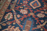 Intricate hand-knotted pile of antique Mahal featuring indigo, red, and moss green motifs.