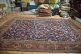 Intricate sprawling design and borders of an antique Mahal rug, deep indigo and rust.