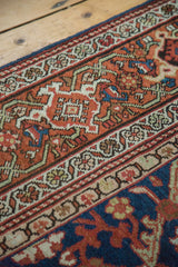 Hand-knotted patterns and panel outlines of an antique Mahal carpet in rust, indigo, and cream.
