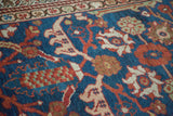 Detail of antique Persian Mahal: indigo field, terracotta vine, blush floral motifs.