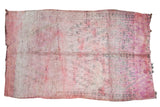 Vintage Moroccan carpet in overdyed cranberry, violet, faded geometric pattern, tattered ends.