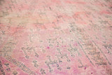 Detail of plush Moroccan carpet pile with concentrated cranberry mauve and violet tones.