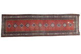Distressed Persian Malayer runner with bold diamond medallions on a cherry red paisley field.