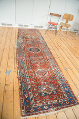 Distressed Karaja runner with brick red field, sky blue borders, and alternating medallions.
