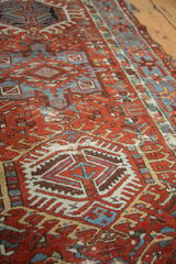 Distressed Persian Karaja runner detail, with brick red, sky blue geometric patterns.