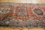 Distressed Karaja runner, brick red field with sky blue geometric patterns, light tattered ends.