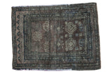 Distressed Oushak square rug in charcoal, chocolate, and slate blue with faded geometric medallions.