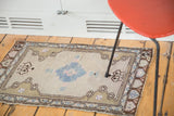 Vintage Oushak rug mat with pale teal floral medallion, beige-grey field, and geometric patterns.