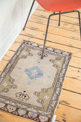 Vintage Oushak rug corner detail, faded moss green and blue geometric border.