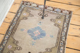 Pale teal floral relief, dark geometric motifs, and intricate patterned border.
