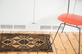 Vintage Oushak rug mat with striking geometric medallions in natural brown and cream tones.