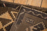 Densely woven vintage Oushak rug, geometric brown and faded tangerine pattern, wear visible.