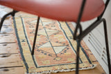 Textured hand-knotted Oushak mat with faded terra cotta, ivory, navy geometric designs.