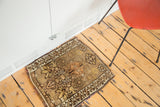 Vintage Oushak rug corner with geometric tribal border and curvilinear earth tone patterns.