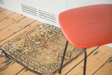 Vintage Oushak rug corner with tribal geometric patterns, earthy tones, secured side, and compact fringe.