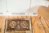 Geometric medallion motif of a vintage Turkish Oushak rug in earthy browns and beige.