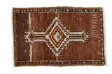 Vintage Oushak rug mat with coffee brown field, tribal diamond medallion, and geometric border.