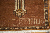 Weaver's name ISHMAEL on vintage Oushak rug's coffee brown field with geometric border and fringe.