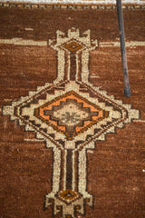 Vintage Oushak rug with tribal diamond medallion and emerging arrows in sand, tangerine, coffee brown.