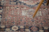 Weathered Oushak rug patterns: blush rose, sand, and navy geometric floral motifs.