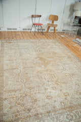 Distressed Mahal carpet with geometric quatrefoil panels and muted floral motifs in light brown and ivory tones.