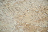 Distressed Mahal rug section with geometric quatrefoil, floral patterns, and neutral tones.