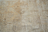 Mahal carpet distressed texture featuring geometric quatrefoil and simplistic floral bouquets.