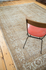 Mahal carpet's distressed geometric quatrefoil pattern in neutral ivory and light brown.