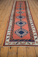 Corner view of vintage Sarab runner showing fringe, secured selvage, and water motif border.
