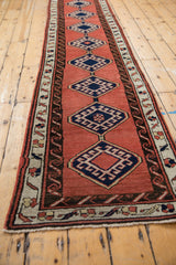 Hand-knotted Sarab rug border featuring navy geometric motifs, reciprocating water design, and fringe.