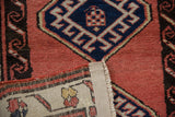 Hand-knotted foundation and faded brick red pile of a vintage Sarab rug runner.