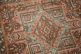 Distressed brick red, dusty green geometric pattern and wear on vintage Karaja rug.