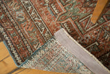 Vintage Karaja runner's distressed brick red geometric pattern and hand-knotted foundation.