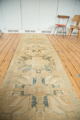Vintage Caucasian Oushak runner with rectilinear eagle medallions in lemony gold and faded teal.