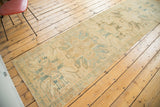 Segment of vintage Oushak runner with lemony gold and faded teal eagle style medallions.