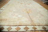 Vintage Oushak runner with minimalist bronze medallion, subtle abrashes, and geometric brown border.