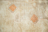 Wool pile texture of vintage Oushak rug, showing abrash and soft bronze diamond design.