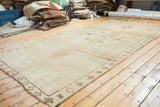 Oushak rug runner's original side cord selvage, geometric border, and soft bronze abrash.
