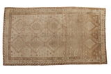 Distressed vintage Oushak rug runner, repeating geometric medallions in muted silver and bronze tones.
