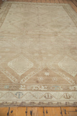 Distressed vintage Oushak rug close-up showing tone-on-tone geometric patterns and even pile wear.