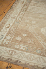 Distressed Oushak runner's tone-on-tone abrash texture in faded bronze and silver.