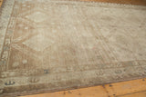 Distressed Oushak runner with muted bronze and platinum tones, abrash, and geometric Caucasian border.